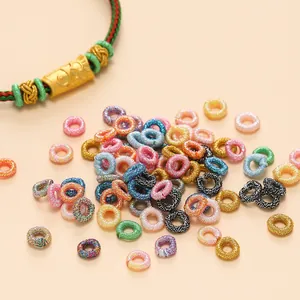 Detailed macro shot of various colorful glitter silk thread coils for DIY jewelry making