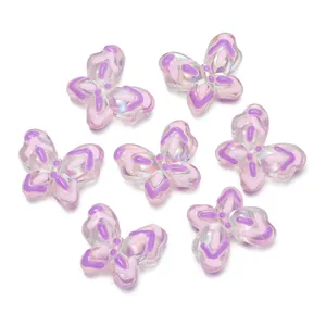 Vue détaillée de perles papillon en acrylique translucide pour la création de bijoux.
