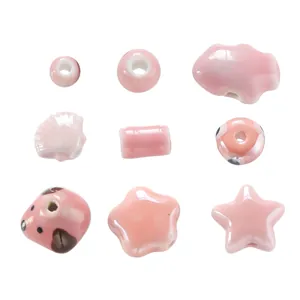 Detail view of assorted pink ceramic beads with glossy cream texture for DIY crafts
