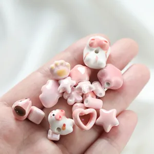 Close-up of pink and white irregular ceramic beads with a creamy glazed texture