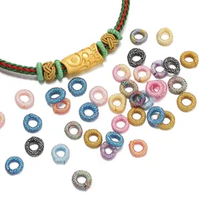 Macro view of colorful iridescent thread rings for DIY handmade jewelry crafting