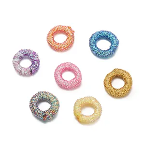 Close-up of colorful metallic thread wrapped rings for DIY jewelry and accessory making