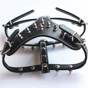 Detail of black PU leather dog harness with silver punk spikes and metal buckles.