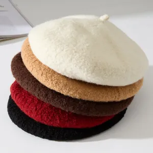 Close-up detail of multi-colored plush winter berets showing soft wool-like texture.
