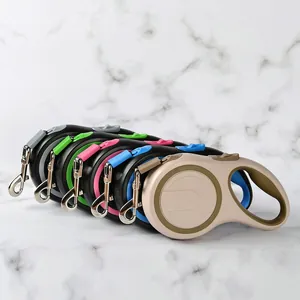Professional retractable dog leashes in multiple colors displayed on marble background