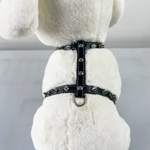 Close-up of a black PU leather dog harness with silver punk spikes and metal D-ring