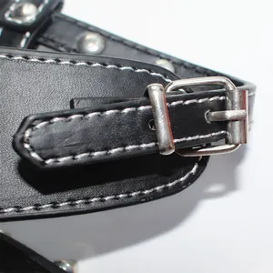 Close-up detail of black punk style PU leather dog harness with durable metal buckle and rivets