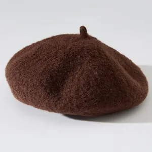 Detailed view of thick retro brown wool beret hat with soft plush texture for winter