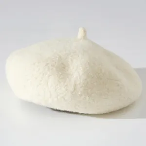 Close-up detail showing the soft and thick plush texture of a cream-white woolen beret hat