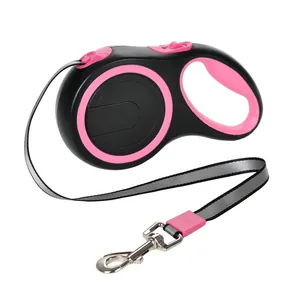 Detailed side view of a black and pink retractable dog leash with reflective tape.