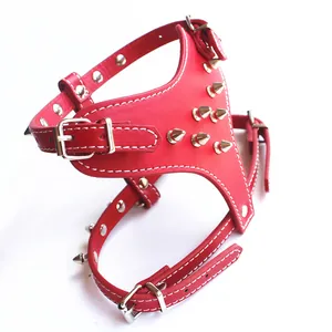Detailed close-up of a red punk style dog harness featuring silver metal spikes
