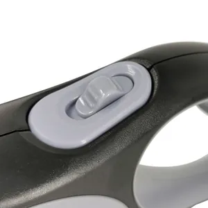 Close-up detail of the anti-slip sliding brake button on a retractable dog leash handle