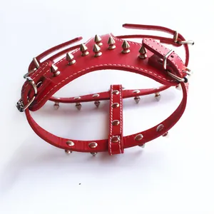 Detailed view of red PU leather dog harness featuring sharp silver punk style metal spikes