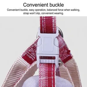 Close-up of the durable grey quick-release buckle on a red checkered pet dog harness