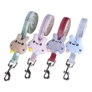 Four colorful plaid pet leashes featuring cute plush bunny decorations and metal hooks
