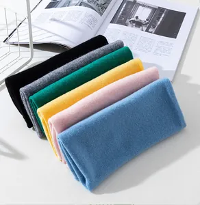 Close-up of seamless merino wool neck warmers in various colors with fine knit texture