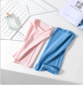 Close-up of soft pink and blue merino wool neck warmers in a lifestyle setting