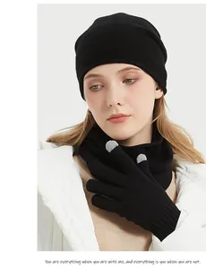 Detailed view of soft black merino wool neck warmer and matching beanie set on model
