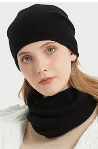 Close-up detail of soft black merino wool knitted neck gaiter and beanie set