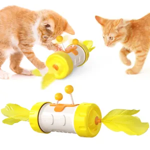 Two orange kittens playing with a yellow tumbler cat toy featuring dual feathers