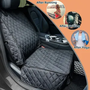 Detailed view of a waterproof black quilted car seat cover installed in a vehicle