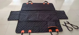 Vue détaillée du couvre-siège de voiture pour chien matelassé noir avec sangles orange.