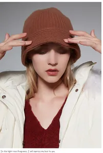 Detailed close-up of a woman wearing a high-quality brown wool knitted bucket hat.