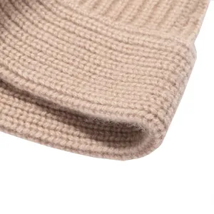 Close-up of a premium thick beige wool knitted bucket hat with a soft ribbed texture