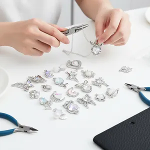 Close-up of DIY jewelry making with silver alloy and iridescent white glass pendants