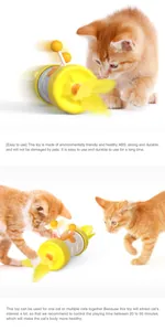 Detail showing kitten playing with an interactive yellow tumbler cat toy with feathers.