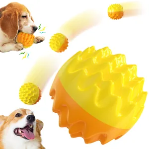 Dynamic view of yellow and orange spiky dog molar ball showing movement and pet play.