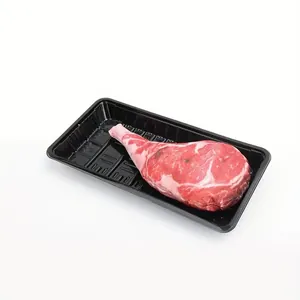 Jouet à mâcher pour chien en forme de steak Tomahawk dans un plateau à viande noir