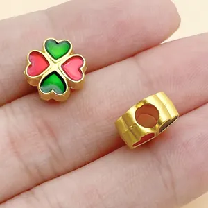 Detailed close-up showing golden alloy four-leaf clover charm and heart spacer beads