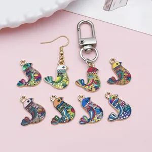 Detailed view of bohemian colorful enamel bird charms for DIY jewelry and keychains.