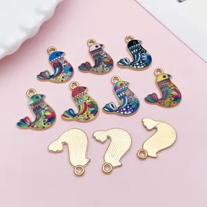 Close-up of ethnic style colorful bird alloy enamel charms for DIY jewelry making.