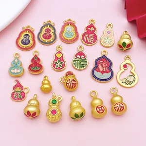 Close-up of matte gold gourd pendants with colorful enamel lotus and fortune designs
