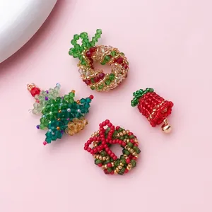 Detailed view of handcrafted beaded Christmas tree and wreath charms for DIY jewelry