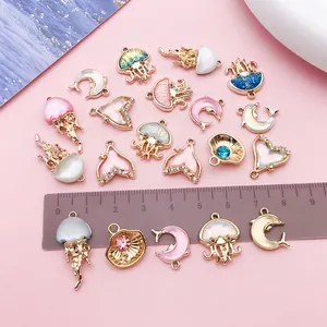 Detailed macro view of ocean-themed oil-drop charms with ruler for scale reference.