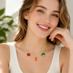 Close-up of a blonde model wearing a cute vegetable charm necklace with tomato and carrot.