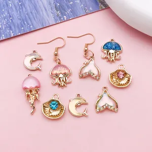 Detailed macro view of assorted ocean-themed drip oil charms including jellyfish and shells