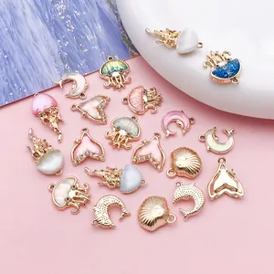 Detailed close-up view of ocean themed enamel charms including jellyfish and dolphin shapes