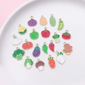 Collection of assorted vegetable enamel charms neatly arranged on a white ceramic plate