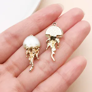 Close-up of gold-plated jellyfish charms for DIY jewelry making