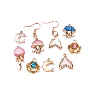 Collection of gold-plated ocean themed charms and earrings with jellyfish and shells