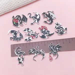 Detailed view of dark gothic dragon enamel charms with ruler for size reference