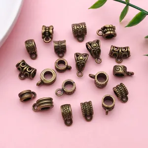 Macro view of vintage bronze alloy bail beads with intricate patterns for DIY jewelry