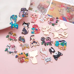 Close-up of colorful cartoon cat enamel charms with floral patterns for DIY jewelry making.