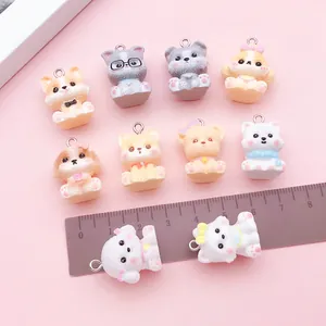 Assorted 3D cartoon dog resin charms for DIY jewelry with ruler for scale demonstration