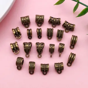 Detailed macro view of various antique bronze alloy bail beads with vintage patterns for DIY