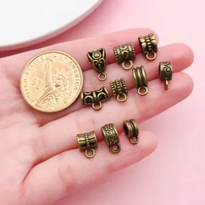 Detailed macro view of antique bronze vintage pattern bail beads for DIY jewelry making